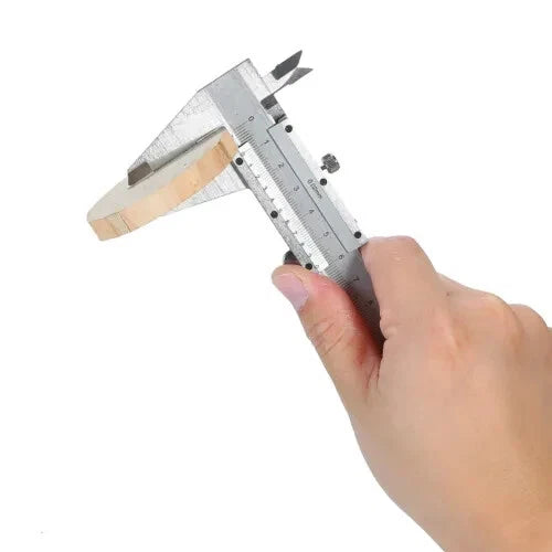 Close up of hand using stainless steel vernier caliper to measure thickness of a wooden disc
